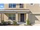 Covered front porch with a dark-brown door and sidelights at 16743 Carlton Pond St, Wimauma, FL 33598