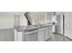 Modern kitchen with gray cabinets, granite countertops, and island at 16743 Carlton Pond St, Wimauma, FL 33598