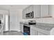 Modern kitchen with stainless steel appliances and granite countertops at 16743 Carlton Pond St, Wimauma, FL 33598