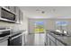 Kitchen with stainless steel appliances and view of backyard at 16743 Carlton Pond St, Wimauma, FL 33598