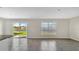 Living room with sliding glass doors leading to backyard and lake view at 16743 Carlton Pond St, Wimauma, FL 33598