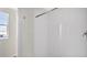 Clean, white tiled shower with a shower rod at 16743 Carlton Pond St, Wimauma, FL 33598
