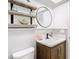 Updated bathroom features floating shelves and a round mirror at 4405 Vieux Carre Cir # 46, Tampa, FL 33613