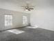 Spacious bedroom with two windows and grey carpeting at 4405 Vieux Carre Cir # 46, Tampa, FL 33613
