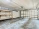 Garage with overhead door and wooden shelving at 4405 Vieux Carre Cir # 46, Tampa, FL 33613