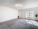 Living room features carpet, large window, and chandelier at 4405 Vieux Carre Cir # 46, Tampa, FL 33613