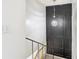 Elegant stairwell with a modern light fixture and dark accent wall at 4405 Vieux Carre Cir # 46, Tampa, FL 33613