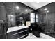 Modern bathroom with black marble tile and contemporary fixtures at 6208 Spoonbill Dr, New Port Richey, FL 34652