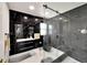 Modern bathroom with black marble and walk-in shower at 6208 Spoonbill Dr, New Port Richey, FL 34652