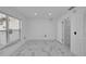 Simple bedroom with white walls and marble tile floors at 6208 Spoonbill Dr, New Port Richey, FL 34652