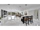 Open concept dining area with marble floors and modern chandelier at 6208 Spoonbill Dr, New Port Richey, FL 34652