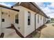 Side view of a house with a landscaped walkway and exterior door at 6208 Spoonbill Dr, New Port Richey, FL 34652