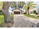 Single-story house with a paver driveway and palm trees in the front yard at 6208 Spoonbill Dr, New Port Richey, FL 34652