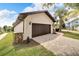Side view of a single story home with stone accents and landscaping at 6208 Spoonbill Dr, New Port Richey, FL 34652
