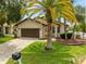 House exterior showcasing a two-car garage and landscaped yard at 6208 Spoonbill Dr, New Port Richey, FL 34652