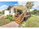 Back exterior showcasing a deck and stairs leading to the backyard at 6208 Spoonbill Dr, New Port Richey, FL 34652