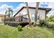 Back of house with deck and landscaping at 6208 Spoonbill Dr, New Port Richey, FL 34652