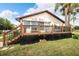 Back of house featuring a large deck at 6208 Spoonbill Dr, New Port Richey, FL 34652