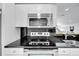 Stainless steel kitchen appliances including microwave and stovetop at 6208 Spoonbill Dr, New Port Richey, FL 34652