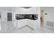 White kitchen cabinets and black countertop with corner sink at 6208 Spoonbill Dr, New Port Richey, FL 34652