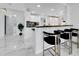 Modern kitchen with white cabinets, breakfast bar, and black countertops at 6208 Spoonbill Dr, New Port Richey, FL 34652