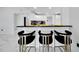 Modern kitchen island with seating for three, black countertop, and stainless steel accents at 6208 Spoonbill Dr, New Port Richey, FL 34652