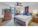 Cozy bedroom with wood furnishings, large window and soft, neutral carpet at 8272 Artisan Way, Seminole, FL 33777