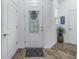 Inviting entryway featuring a decorative glass front door, stone rug and neutral color palette at 8272 Artisan Way, Seminole, FL 33777