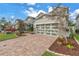 Attractive home showcasing a paved driveway, well-kept lawn, and a two-car garage at 8272 Artisan Way, Seminole, FL 33777