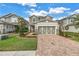 Charming home with a well-manicured lawn, paved driveway, and a two-car garage at 8272 Artisan Way, Seminole, FL 33777