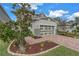 Beautiful two-story home featuring a two-car garage and a brick-paved driveway, with an emphasis on curb appeal at 8272 Artisan Way, Seminole, FL 33777
