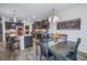 Open kitchen with dark wood cabinets, stainless steel appliances, pendant lighting, and adjoining dining area at 8272 Artisan Way, Seminole, FL 33777