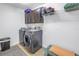 Well-equipped laundry room with modern washer and dryer, storage cabinets, and tile flooring at 8272 Artisan Way, Seminole, FL 33777