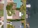Aerial view of a waterfront home with private dock and lush landscaping at 911 Silver Palm Way, Apollo Beach, FL 33572