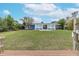 Spacious backyard with a canal view and a dock at 911 Silver Palm Way, Apollo Beach, FL 33572