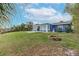 Backyard view of home featuring a fire pit and canal access at 911 Silver Palm Way, Apollo Beach, FL 33572