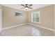 Well-lit bedroom with tile floors and plantation shutters at 911 Silver Palm Way, Apollo Beach, FL 33572