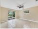 Bright bedroom with tile floors and sliding glass doors to patio at 911 Silver Palm Way, Apollo Beach, FL 33572