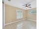 Spacious bedroom with tile floors and large window at 911 Silver Palm Way, Apollo Beach, FL 33572