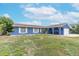 Ranch-style home with a large yard and blue exterior at 911 Silver Palm Way, Apollo Beach, FL 33572