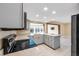 Modern kitchen with gray cabinets, granite counters, and breakfast bar at 911 Silver Palm Way, Apollo Beach, FL 33572