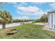 Relaxing waterfront view with lush grass and dock at 911 Silver Palm Way, Apollo Beach, FL 33572