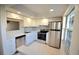 Modern kitchen featuring stainless steel appliances and white cabinetry at 970 Virginia St # 109, Dunedin, FL 34698