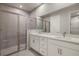Modern bathroom with double vanity, quartz countertop, and a large walk-in shower at 12318 Hearts Ease St, Venice, FL 34293