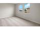 Bright bedroom with carpeting, neutral walls, and large windows offering a scenic view at 12318 Hearts Ease St, Venice, FL 34293