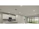 Modern kitchen with white cabinets, stainless steel appliances, and island at 12318 Hearts Ease St, Venice, FL 34293