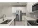 Modern kitchen with stainless steel appliances and white cabinets at 12318 Hearts Ease St, Venice, FL 34293