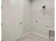 Bright laundry room with white cabinetry and shelving at 12318 Hearts Ease St, Venice, FL 34293