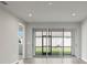 View of living room with sliding glass doors leading to a screened patio at 12318 Hearts Ease St, Venice, FL 34293