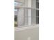 Close-up of a multi-paned window, showcasing the exterior view at 12318 Hearts Ease St, Venice, FL 34293